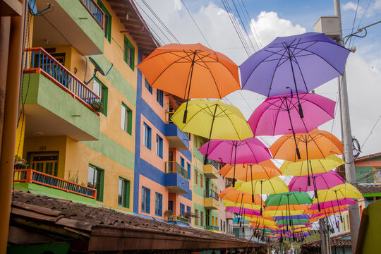 colorful houses and umbrellas on the street in Colombia