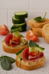 tomato and cucumber sandwiches on a plate