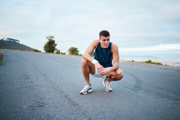 Sports, nature and man athlete breathing on break of race, marathon or competition training and workout. Fitness, fatigue and tired young male runner resting for outdoor cardio exercise for endurance