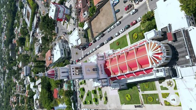 Sacred Heart of Jesus Church or Iglesia Sagrado Corazón De Jesus, Moca in Dominican Republic. Aerial orbiting and vertical format