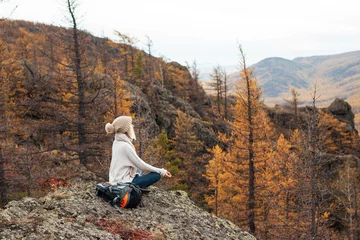 Foto op Plexiglas Woman doing meditation yoga exercise and relaxing in the mountains © Tatyana Gladskih