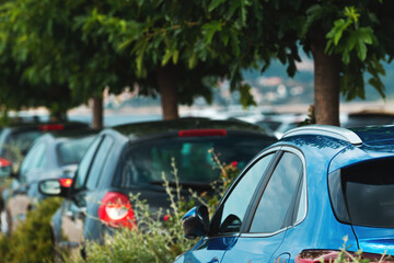 Parked cars on parking lot with trees