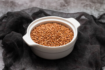 Raw toasted buckwheat in a white ceramic bowl