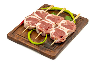 Lamb tenderloin skewer isolated on white background. Raw lamb tenderloin beyti skewer with herbs and spices
