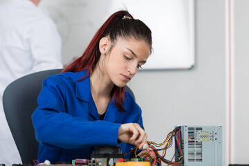 young female electrician at work