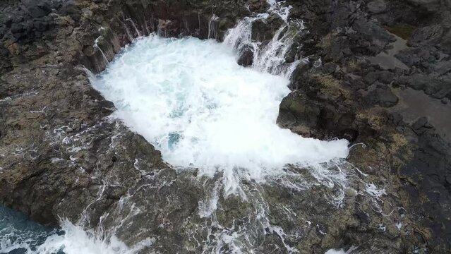 Powerful ocean waves relentlessly carve through volcanic rock formations at El Bufadero de La Garita, producing mesmerizing blowholes and showcasing the raw energy of the Atlantic coast.