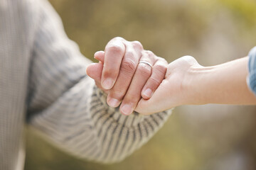 Couple, holding hands and people with trust in nature, garden or backyard with support, care or...