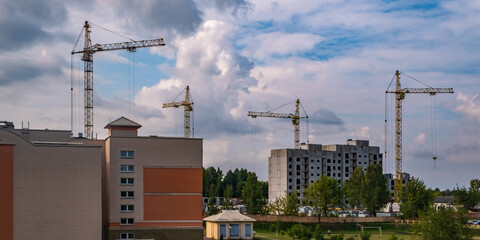 tower cranes on construction site, providing housing for low-income citizens of third world...