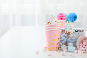 Gift boxes, marshmallows and paper cups on white background, space for text