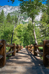 Wooden footbridge  over Merced River to Yosemite Falls in Yosemite National Park, California.