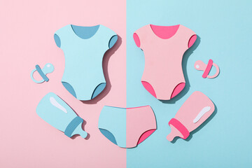 Paper baby things on blue and pink background, top view