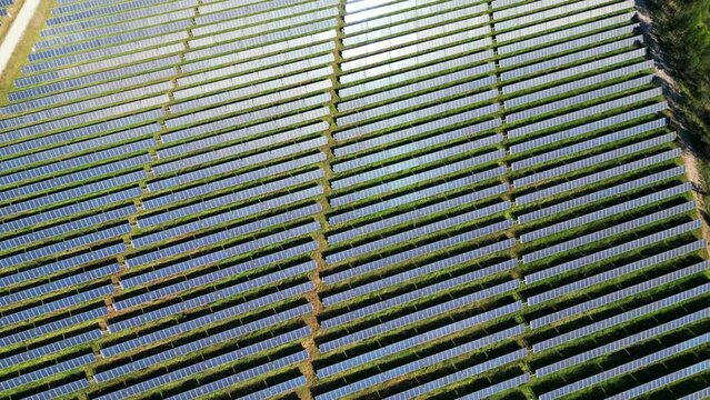 Flying over a photovoltaic farm, with sun refleting on cells,Salvaterra de Magos, Portugal