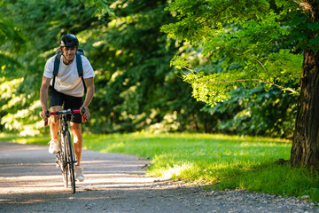 Young athlete on a bike in the sunny summer park