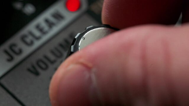 Man tuning equilizer knob on guitar amplifier. 4k video footage UHD 3840x2160