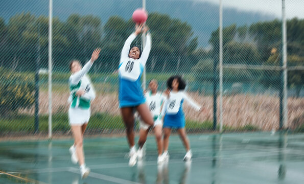 Sports, team and netball with woman jump for ball, competition and athlete playing game, court challenge or active match. Motion blur, action and group workout, exercise and player training together