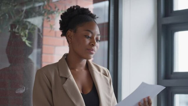 Businesswoman using printer for copying paperwork to businessman colleague in office. Businesswoman helping businessman photocopying paperwork in office