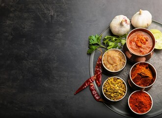 Traditional Indian food with spices on dark background with space for text. AI Generated.