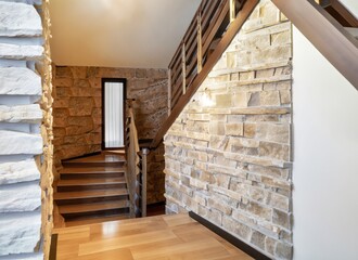 Wooden staircase and stone cladding wall in rustic hallway . Cozy home interior design. AI Generated.