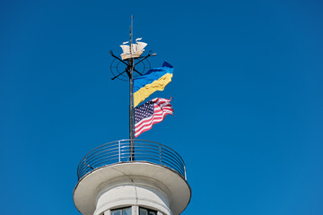 Ukrainian and American flags on a tower in Kyiv - 649640739