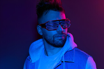 guy in neon cyber glasses on a dark background, cyber space concept