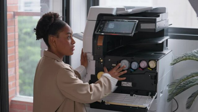 Businessman helping woman colleague using a photocopier machine in office. Photocopy machine was broken. Photocopier or printer has error