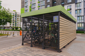 Bicycle garage. Bicycles in a cage on the street. Special garage-cage for bicycles. Bicycle storage device. - obrazy, fototapety, plakaty