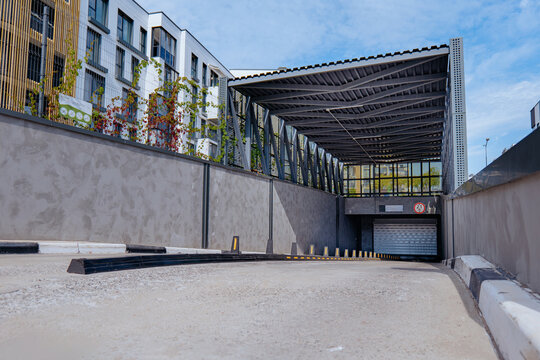 New modern residential apartment house building, garage parking concept. Entrance to underground parking