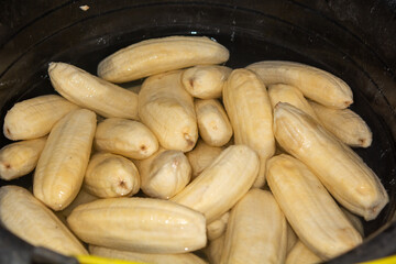 Close up of making a light snack of yellow banana chips