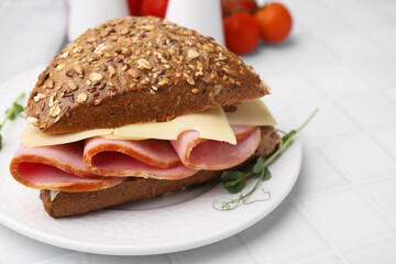 Delicious sandwich with ham and cheese on white table, closeup