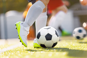 Player Kick a Soccer Ball on a Grass Pitch. Soccer Equipment. The Perfect Football Kick. Young...