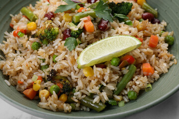 Tasty fried rice with vegetables in bowl, closeup