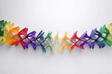 Rainbow paper garland on white background, top view. LGBT pride