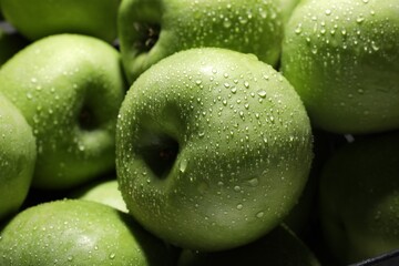Fresh green apples with water drops as background, closeup
