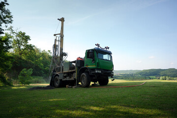 Water well drilling rig preparing to boring dowin into the earth. - obrazy, fototapety, plakaty