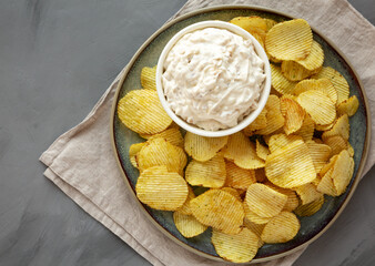 Crispy Crinkle Potato Chips and French Onion Dip on a Plate, top view. Flat lay, overhead, from above.