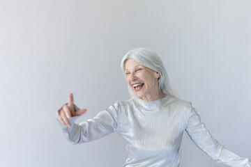 Portrait of a senior woman dancing and having fun