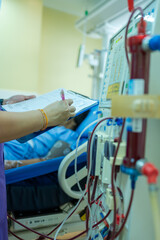 The specialist are checking continuous renal replacement therapy equipment and injection pump and hemodialysis machine.
