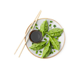 Delicious green dumplings (gyozas) and soy sauce isolated on white, top view
