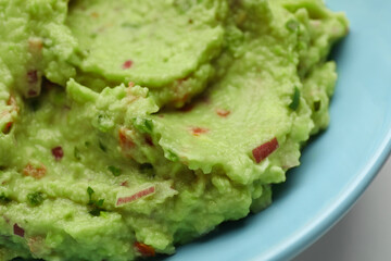 Bowl with delicious fresh guacamole, closeup view