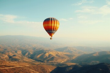 A vibrant hot air balloon gracefully floats above a vast, untouched field, epitomizing freedom and adventure.
