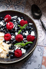 Oatmeal for breakfast with raspberries and blueberries