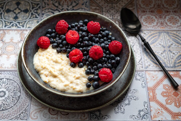 Oatmeal for breakfast with raspberries and blueberries