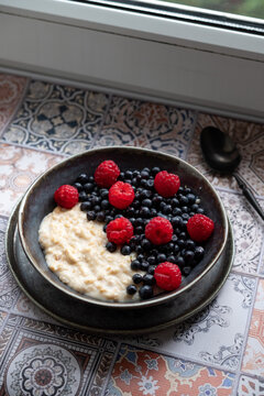 Oatmeal for breakfast with raspberries and blueberries