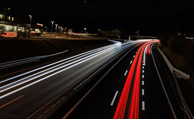 Fototapeta na wymiar Light trails at night on the highway entry