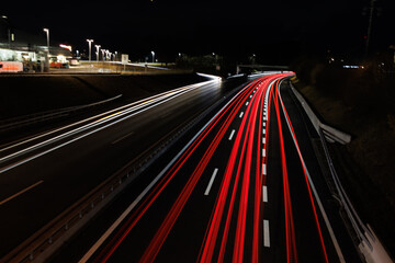 Fototapeta na wymiar traffic on highway at night light trails mainly backlight
