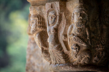 cloister capitals, vices and virtues, women dancing with their arms raised and men sitting ,abbey...