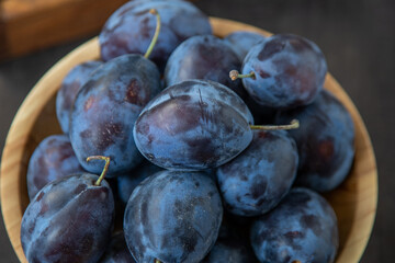 Plum variety Hungarian. Fruit harvest on the table in the kitchen. Autumn blue plum. Vitamin food...