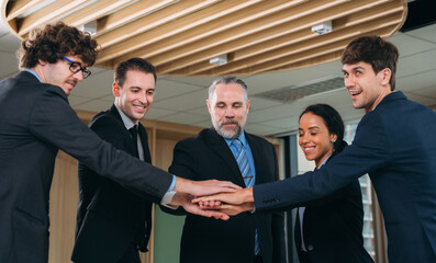 Executives in Formal Attire Mark a Momentous Business Partnership with a Handshake. Professional Colleagues Seal a Lucrative Business Deal with a Handshake and Contract Signing.