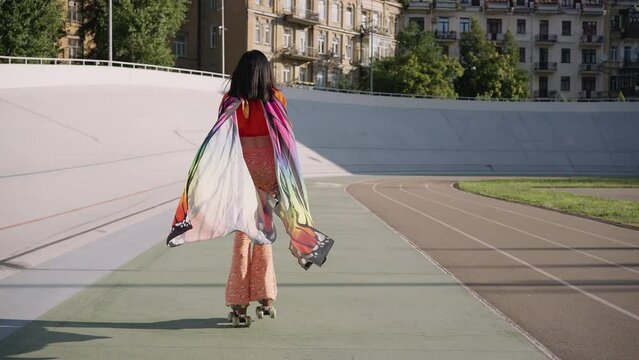Woman rollerblading in design costume of butterfly wings
