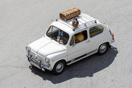 Galicia, Spain; august 27, 2023: High angle view of Seat 600 classic car driving on a road